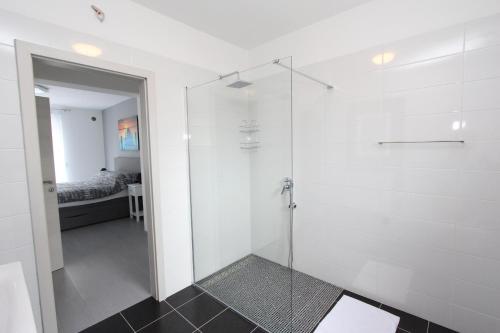 a bathroom with a shower with a glass door at Apartment Karlo 2 in Rovinj