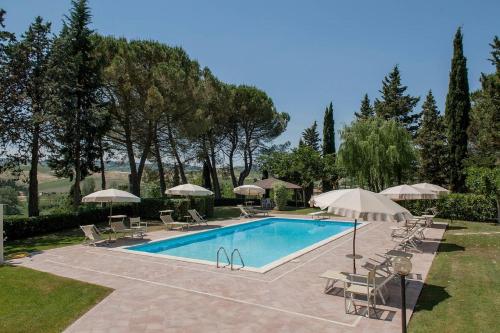 a swimming pool with lounge chairs and umbrellas at Azienda Agricola e Agriturismo Vallorsi in Terricciola