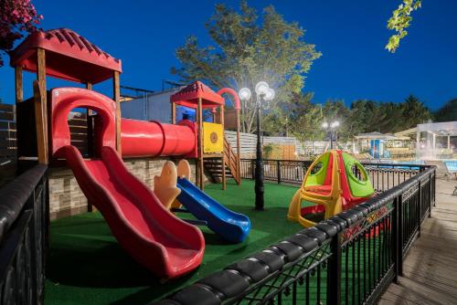 a playground with a slide and slidesktop at Denise Beach Hotel in Laganas