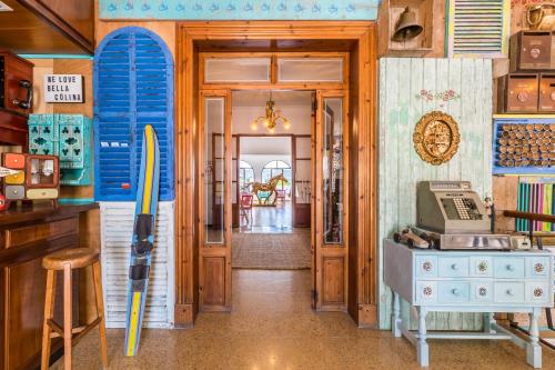 a room with a door with a surfboard on the wall at Bella Colina I Vintage Hotel 1953 in Paguera