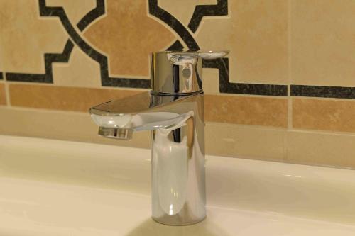 a bathroom sink with a soap dispenser on it at B&B Residenza Via Dei Mille in Naples