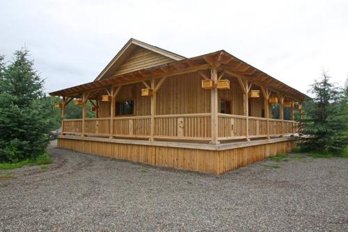 a large wooden cabin with a large deck at LDR Lodge - Last Dollar Ranch in Smithers