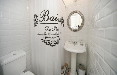 a bathroom with a sink and a toilet and a mirror at Vidéki Varázs Vendégház in Bogács