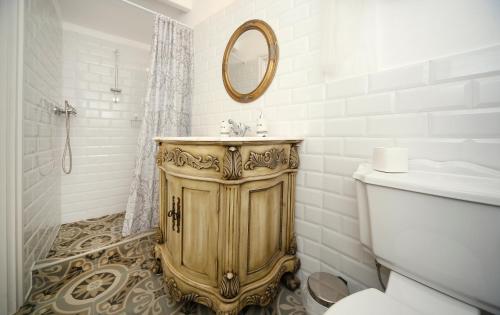a bathroom with a sink and a mirror at Vidéki Varázs Vendégház in Bogács