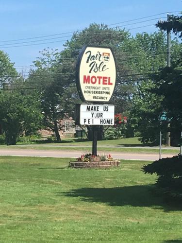 a sign for a motel in the middle of a field at Fair Isle Motel in Charlottetown