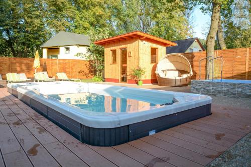 a large pool on a deck with a house at Hotel Lukács Superior in Kazincbarcika