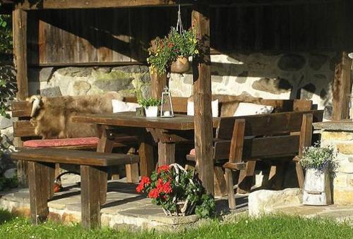 a wooden picnic table and bench in a yard at Fleckhof in Neustift im Stubaital
