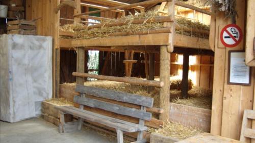 a building with a bench in front of a barn at Steigmatt Bauernhof- Erlebnis in Montlingen