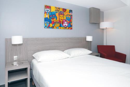 a bedroom with a white bed and a painting on the wall at Best Western Linko Aubagne in Aubagne