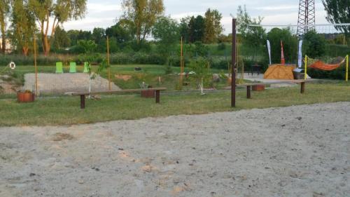 a park with a playground with benches and swings at Verdaine in Verdainė
