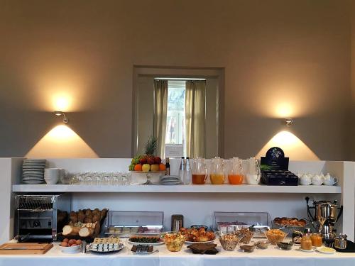 a table with food and drinks on top of it at Hotel Palazzo Vannoni in Levanto