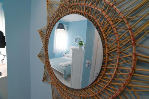 a mirror in a blue room with a bed at Latino Rent Room B&B vista mare in Porto Cesareo