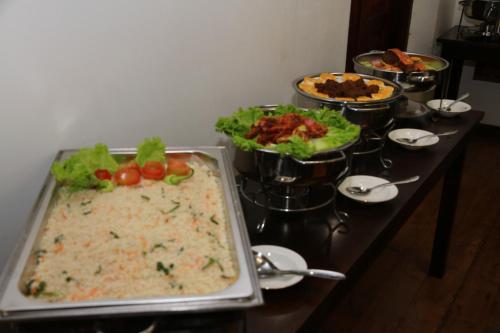 a table with many different dishes of food on it at Thamaya Heritance Tangalle in Tangalle