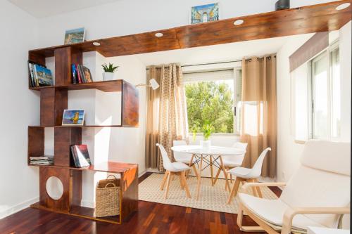 a living room with a table and chairs at Carcavelos Beach Apartment in Cascais