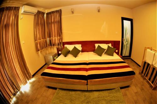 a bedroom with a large bed in a room at Annama Lodge and Dive in Hoarafushi