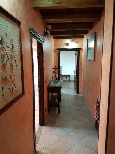 a hallway of a house with a room with a table at Casa Vacanza il Mandorlo in Domusnovas