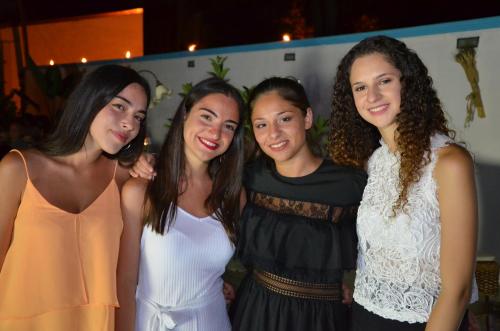 four young women posing for a picture at a party at Ostello Salento in Alezio