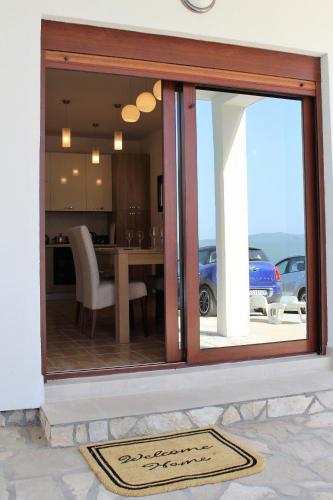 a kitchen and dining room with a sliding glass door at Villa Eva in Radanovići