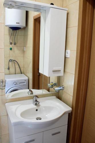 a bathroom with a white sink and a mirror at Villa Eva in Radanovići