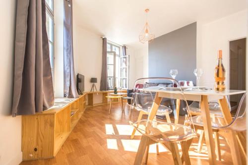 a dining room with a table and chairs at charming city center flat in Rouen