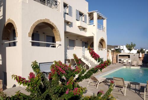 a villa with a swimming pool and flowers at Astarte Sea Villas in Diakofti