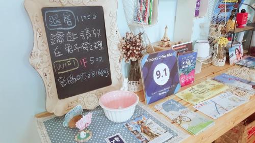 a desk with a chalk board and books on it at Princess Chloe B&B in Hengchun