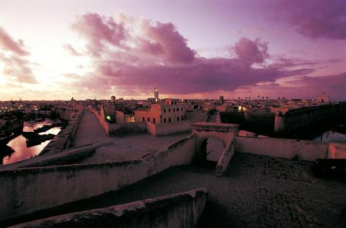 a view of a city at sunset at Appartement Vintage full équipé EL JADIDA in El Jadida