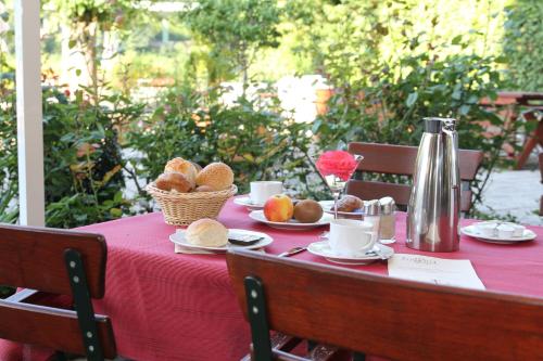 a table with a red table cloth with food on it at Elbhotel Bad Schandau in Bad Schandau