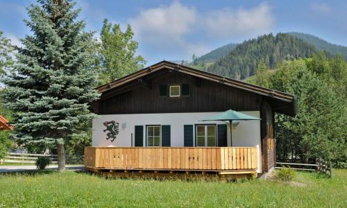 a small house with a porch and an umbrella at Heisshof in Schladming