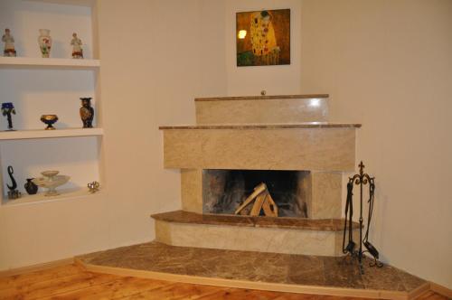 a living room with a stone fireplace in a room at Apartment Chavchavadze 5 in Sighnaghi