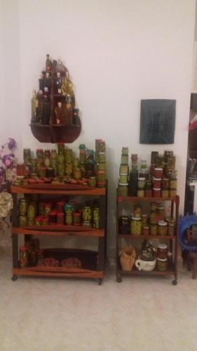 a room with two shelves filled with canned food at L'Oasi in Auletta