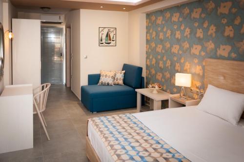 a bedroom with a bed and a couch and a chair at KalyBay in Kalives Poligirou