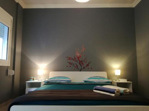 a bedroom with a bed with two night stands and two lamps at Charilaou Trikoupi Flat in Athens