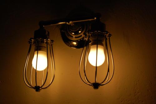 two lights are hanging on a wall at Factoria Hotel in Asuncion