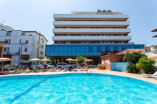 une grande piscine en face d'un bâtiment dans l'établissement Hotel Miramare, à Gatteo a Mare
