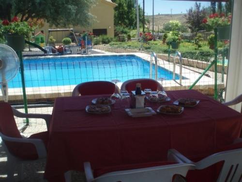 a table with plates of food on it next to a pool at Arcas de Agua in Arcas