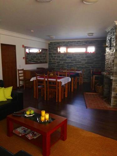 a living room with a table and a dining room at Casa d'Avó Faia in Morais