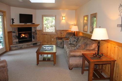 a living room with a couch and a fireplace at Mount Shasta Resort in Mount Shasta