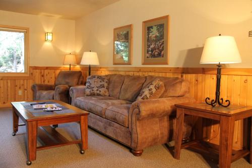 a living room with a couch and two tables at Mount Shasta Resort in Mount Shasta