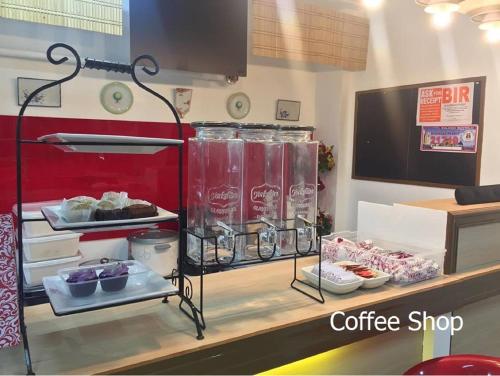a coffee shop with a counter filled with food at Oriental Zen Suites in Manila