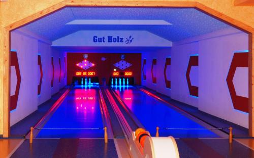 a bowling alley with blue lanes and red lights at Der Brückenhof Ramsau in Ramsau am Dachstein