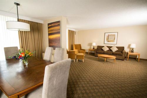 a room with a dining table and a living room at Edmonton Inn and Conference Centre in Edmonton