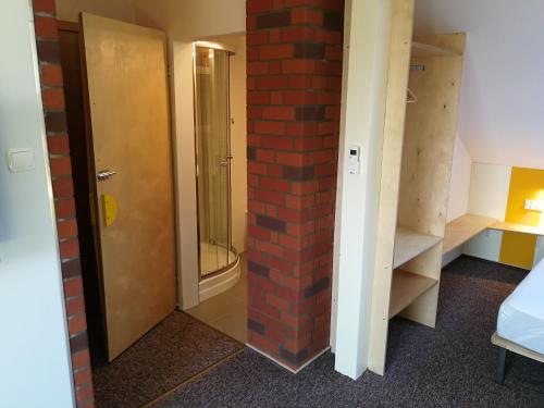 a room with a brick pillar and a door at Kasztanowe Wrota in Kosewo