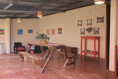 a room with a wooden table and a table and chairs at Hotel Vuelta del Ombu in Gobernador Ingeniero Valentín Virasoro