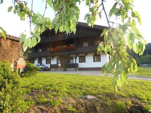 a building with a green lawn in front of it at Schwaighof in Oberau