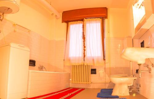 テーリオにあるCulla alpina 3°pianoのバスルーム(トイレ、バスタブ付)、窓が備わります。
