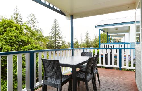 a porch with a table and chairs on a deck at NRMA Port Macquarie Breakwall Holiday Park in Port Macquarie