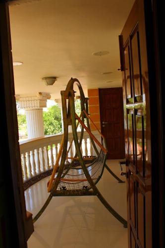 a hammock on the balcony of a house at Classic Dineout in Gandhinagar