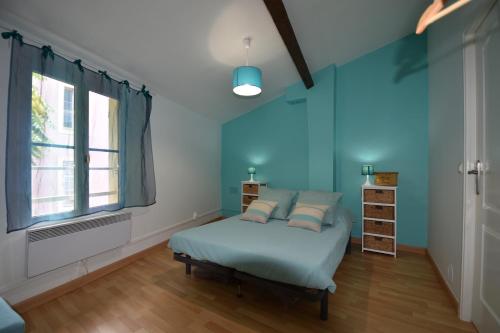 a blue bedroom with a bed and a window at Alezard in Toulon