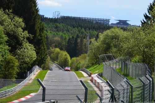 a car is driving down a road with trees at Gästehaus Am Hochsimmer in Ettringen